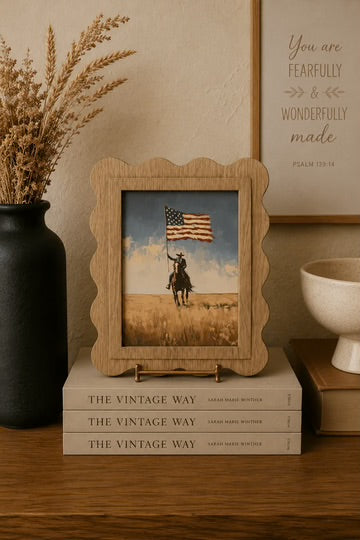 Scallop cowboy with flag arch framed canvas art